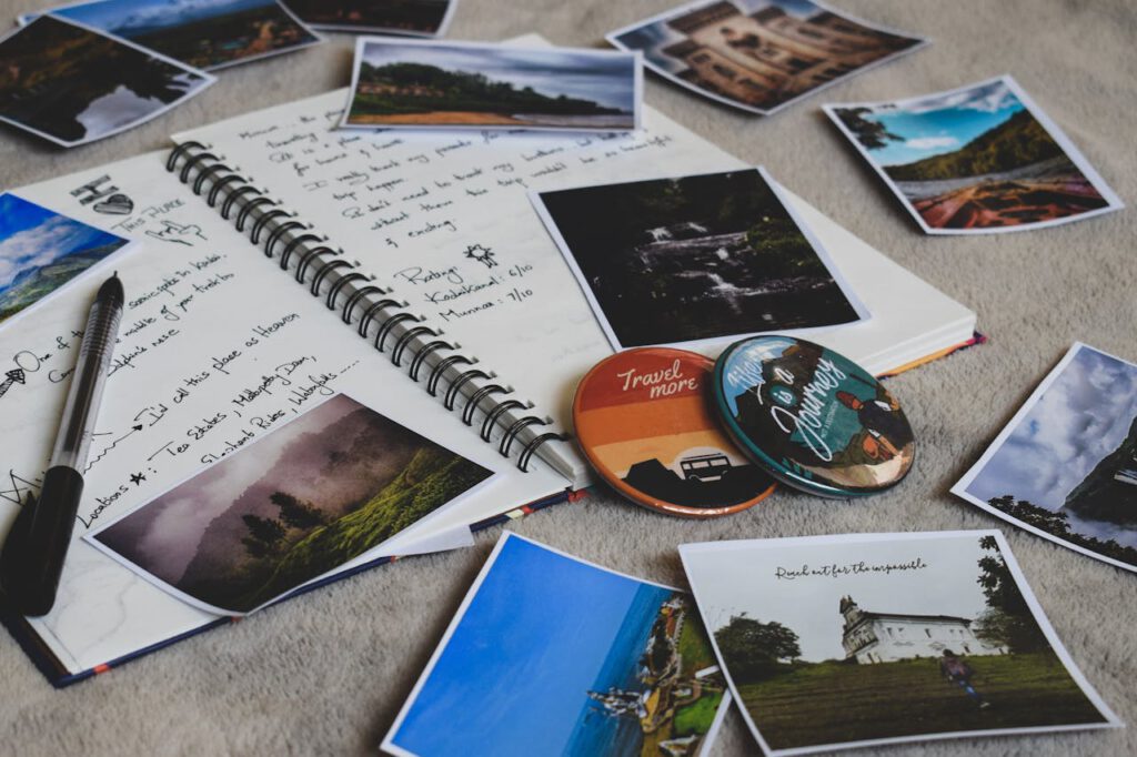 pexels-photo-2874998 Travel diary surrounded by printed photos and a pen, capturing memories creatively.